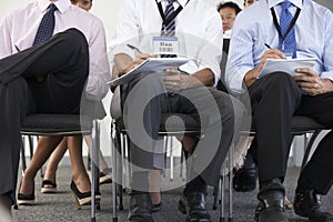 Detail Of Delegates Listening To Presentation At Conference