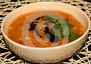 Detail of dense Lentil soup with tomatoes and carrot