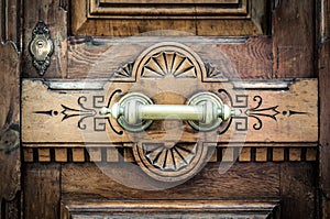 Detail of door with metal handle and keyhole.