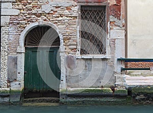 Detail of a door over a canal, Venice, Italy.