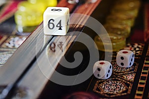 Detail of the doubling cube on the center rail of a lacquered backgammon board, macro