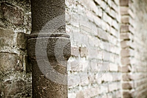 Detail of a downpipe against a brick wall - Tuscany - Italy