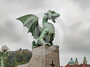 Detail of the Dragon Bridge in Ljubljana, Slovenia, on an autumn day, against the cloudy sky