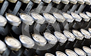 Detail of the dusty keys of an old typewriter. Journalism and writing activities