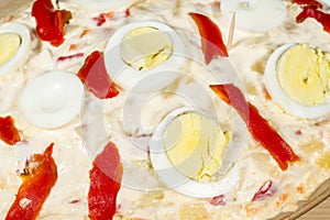 Detail of eggs and red peppers of a Russian salad (also known as Olivier salad)