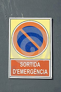 Detail of emergency exit sign board, written in catalan: photo