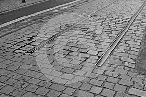 Detail of an end of rail tracks among cobbled road as a symbol of terminal station