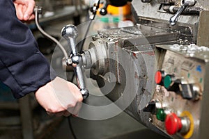 Detail Of Engineers Hands Operation Controls On Lathe