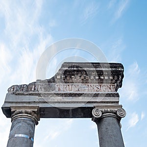 Detail of the entrance door of the ancient Greco-Roman amphitheater in Catania, on a background with blue sky