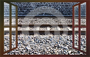 Detail of an european railway with metal train tracks over a roadbed stones - concept image iew from the window photo
