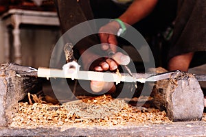 Detail of the extremities of a man working with wood in a workshop