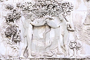 Detail of the facade of the Duomo of Orvieto, Italy. Marble bas-relief representing episodes of the bible. Adam and Eve