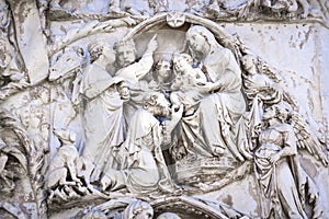 Detail of the facade of the Duomo of Orvieto, Italy. Marble bas-relief representing episodes of the bible. Adoration of the Magi