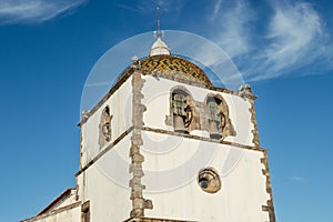 Detail of the facade and singular dome of the bell tower with its arches of the Mother Church of PedrogÃÂ£o Grande PORTUGAL photo