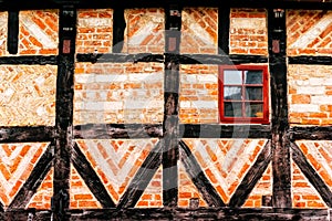 Detail of facade of old house made of wood and bricks in Malmo