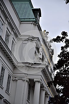 Detail of the facade of the Techniche Universitat Wien with columns and tree branches in Vienna. photo