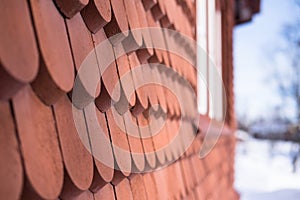 Detail of the falured red painted wooden exterior covering Of Kiruna Church in Sweden