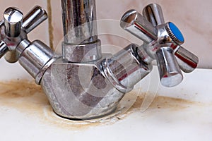 Detail of faucet with limescale or lime scale on it, dirty calcified and rusty kitchen mixer tap, close up