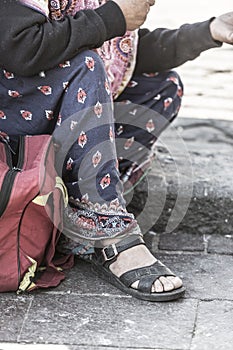 Detail of the feet of the homeless woman