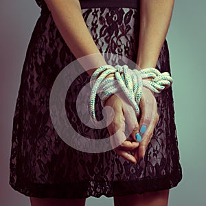 Detail of female hands tied up