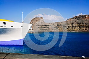 Detail of a ferry moored at Puerto de las Nieves in the Canary Islands on a sunny day of intense and luminous blue color