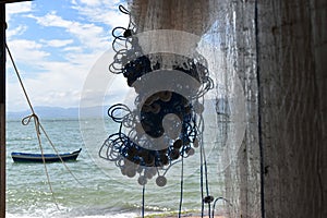 detail of fisherman net with little boat in the sea photo