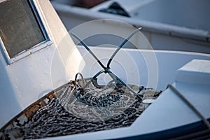 Detail of fishing boat with anchor and rope. Selective focus