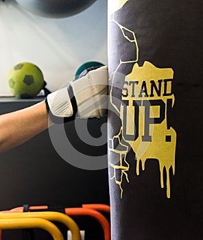 Detail of a fist of a woman hitting a punching bag