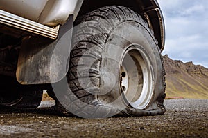 Detail of a flat black offroad tire on a offroad truck vehicle