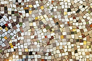 Detail of a floor with irregular patterns of colorful ceramic tiles