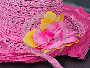 Detail of flowers on the women's pink straw hat
