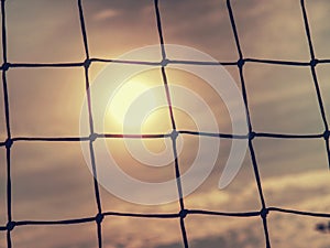 Detail of football gate net in evening sun. The goal net