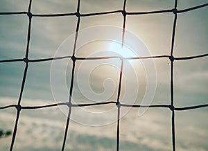 Detail of football gate net in evening sun. The goal net