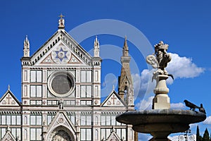 Detail of fountain in piazza Santa Croce, Florence, Italy, in the background the Basilica of Santa Croce