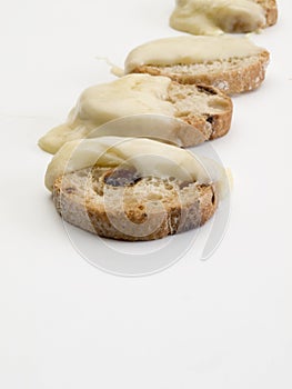 Detail of four bread toast with raisins and melted cheese photo