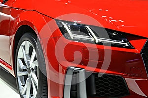 Detail front headlights of red sport car