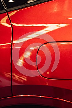 Detail of the fuel tank entry on a red car