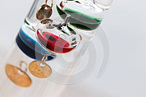 Detail of a galileo thermometer with white background