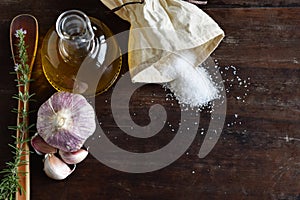 Detail of garlic, sal and oil in rustic backgriund