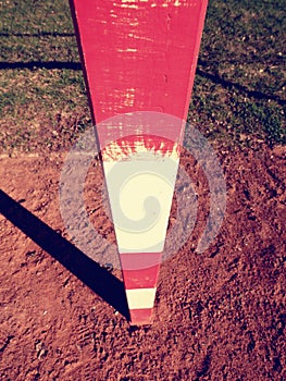 Detail of gate frame . Outdoor football or handball playground, light red clay. Red crushed bricks surface on ground