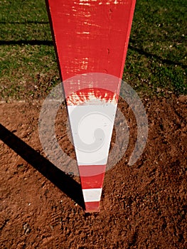 Detail of gate. Outdoor football or handball playground, light red crushed bricks surface on ground