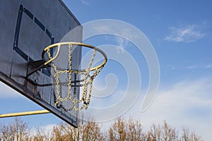 Detail of golden basketball basket outdoors in sunset blue sky