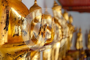 Detail of the golden Buddhas displayed at Wat Pho, Bangkok, Thai