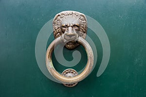 Detail of a golden door knocker on the streets of Venice, Italy