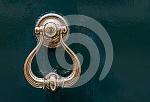 Detail of a golden door knocker on the streets of Venice, Italy