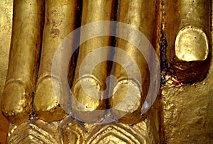 Detail of the golden fingers of one of the hands of a statue of the Buddha. Bagan. Myanmar