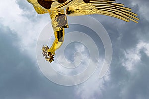 Detail of the golden statue at the victory column in Berlin in a cloudy day photo