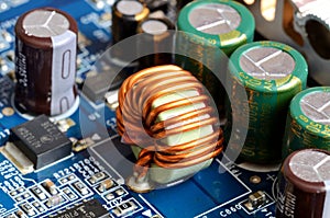 Close-up of inductors, capacitors and chips photo