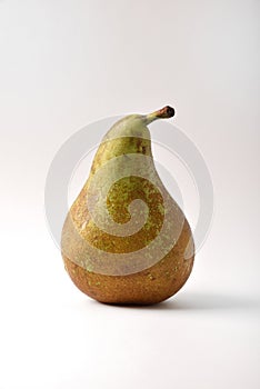 Detail of green and brown pear on white background