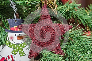 Detail of green Christmas (Chrismas) tree with colored ornaments